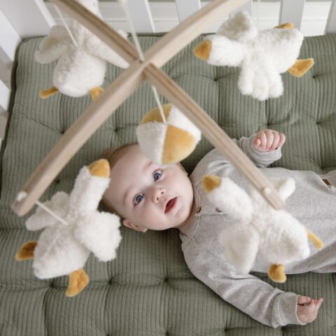 Wooden music mobile Little Goose - This cute wooden Little Goose music mobile has a soothing effect on babies thanks to the sweet lullaby. There are five geese on the mobile and they love to fly in circles to entertain your baby. Watching the music mobile will stimulate visual development. The mobile is suitable for a new born and can easily be attached to a cot or playpen. Pair the music mobile with other items from our Little Goose collection such as a cuddly toy. WARNING: Attach this toy out of the reach of the child. To prevent possible injury by entanglement, remove this toy when the child starts trying to get up on its hands and knees in a crawling position. Adult assembly required. Keep this information for reference.