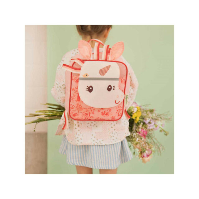 little girl wears unicorn school bag with tassels