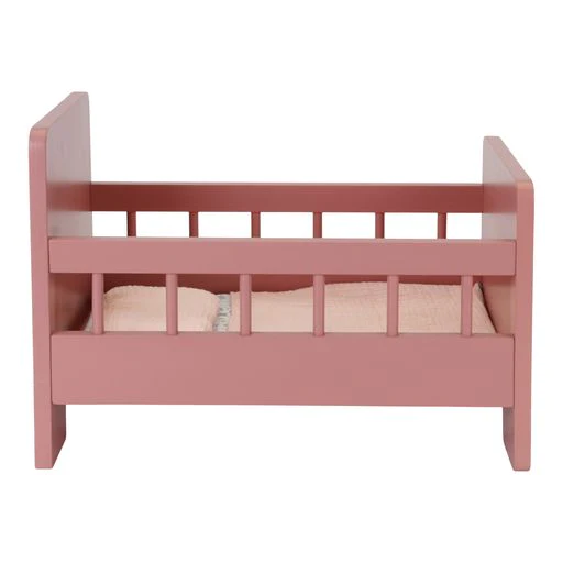 Wooden pink bed with rails and floral bedding