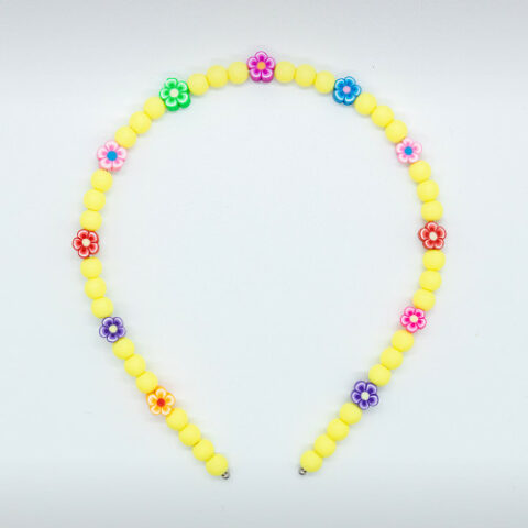 yellow tiara with beads and colored flowers